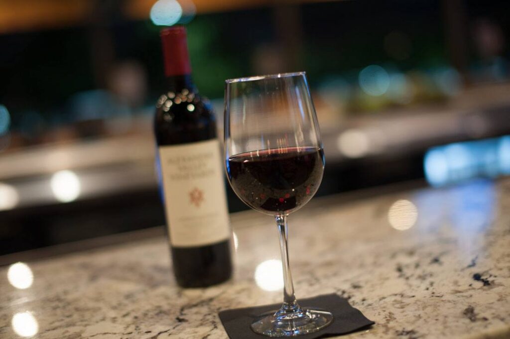 Glass of red wine at PINSTACK's wine bar