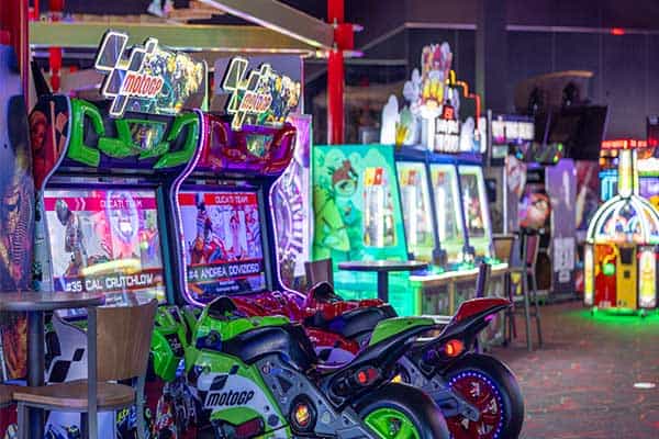 A colorful image of a line-up of motorcycle video games at Pinstack.