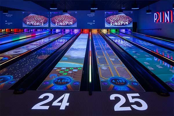 An image from the perspective of a bowler on the VIP Pinstack lanes with SPARK augmented reality in action.